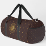 Gold Nautical Duffle Bag A brown duffel bag with a diamond pattern and a compass emblem reading "CAPTAIN" on the side, featuring black straps and a mesh pocket.